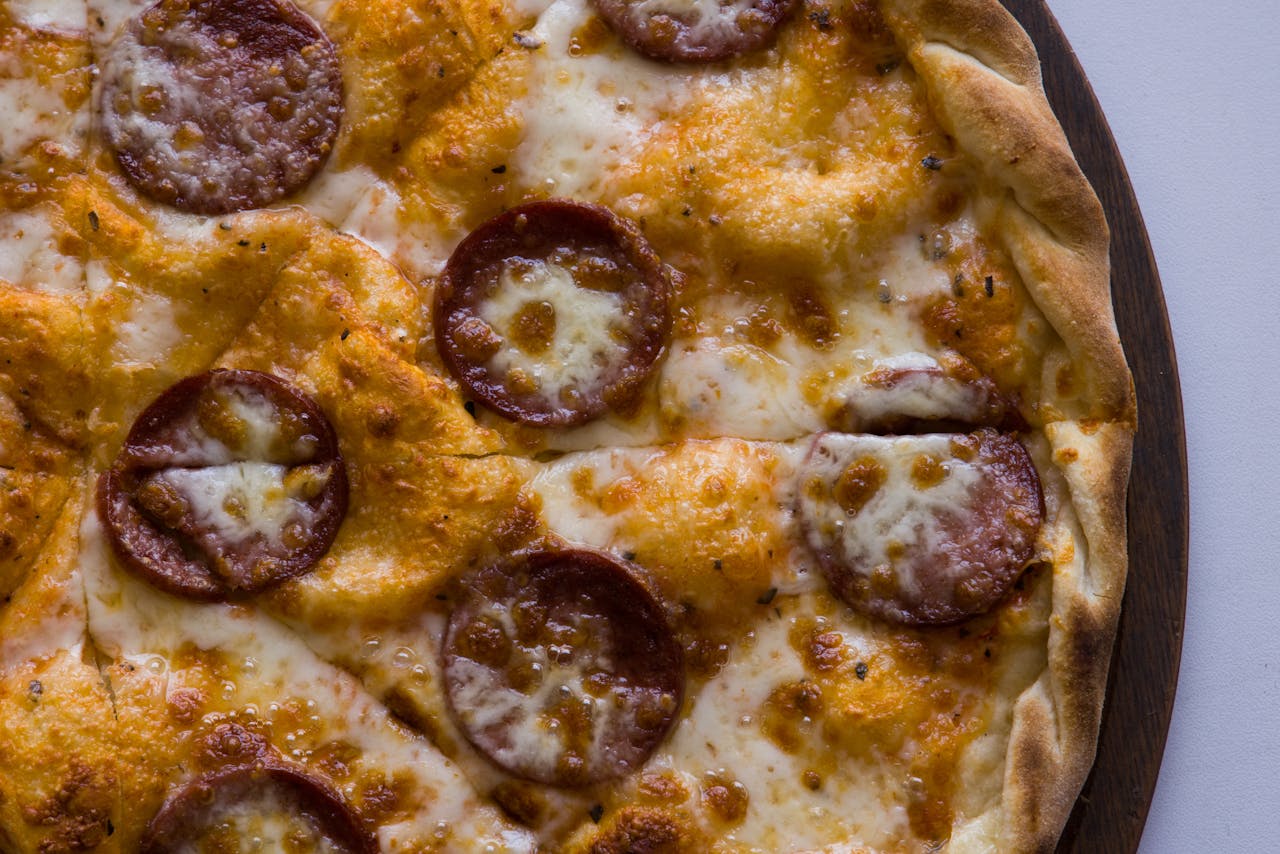 Delicious pepperoni pizza with melted cheese and crispy crust, perfect for food photography.